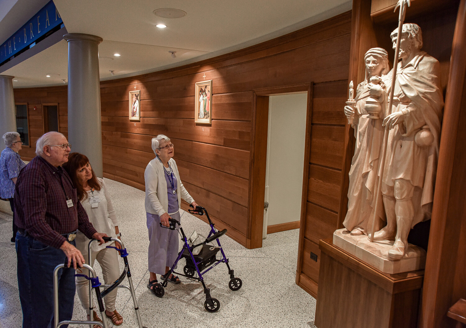 Howard Schneider, left, Rita Rivera and Maxine Walker notice the lifelike eyes of the statues, carved into lindenwood from the Black Forest in Germany. The sculptures are of St. Isidore and his wife Blessed Maria. Isidore is the patron saint of farmers and day laborers and was known for his compassion and kindness. He is said to have brought people home to feed and his wife Maria blessed the hungry with a meal. Rivera serves as director of life enrichment at Heisinger Bluffs and toured the newly renovated Cathedral of St. Joseph Monday with several residents Monday.